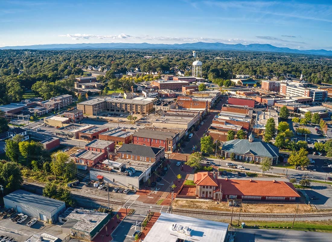 Hampton, SC - Aerial View of Buildings and Apartments Surrounded by Green Foliage in Downtown Hampton South Carolina on a Beautiful Day